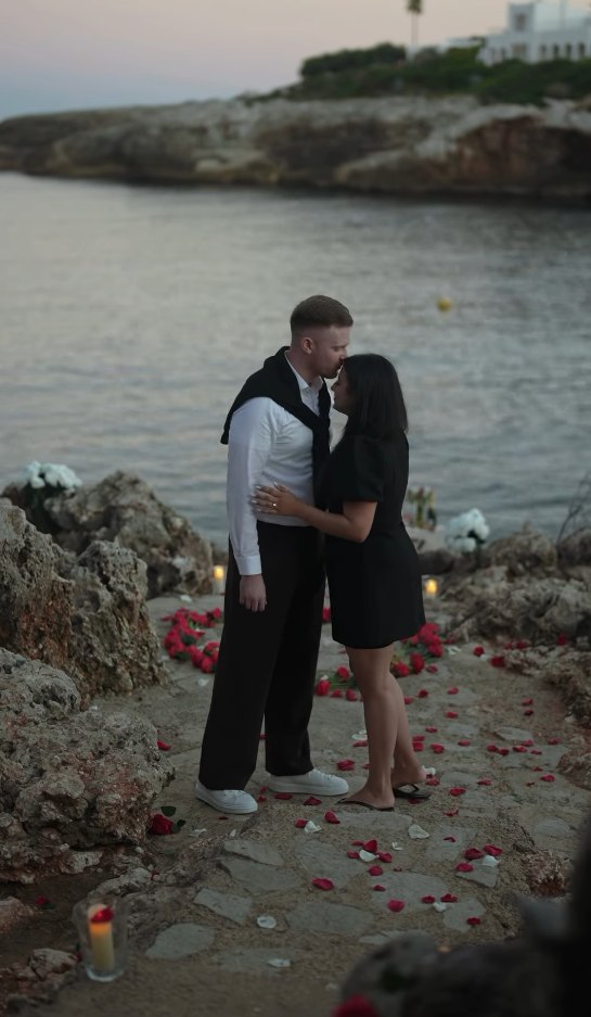 An embrace by the water after the proposal
