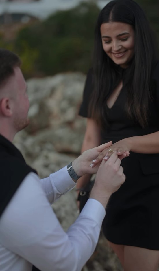 Placing the ring on Rika's finger